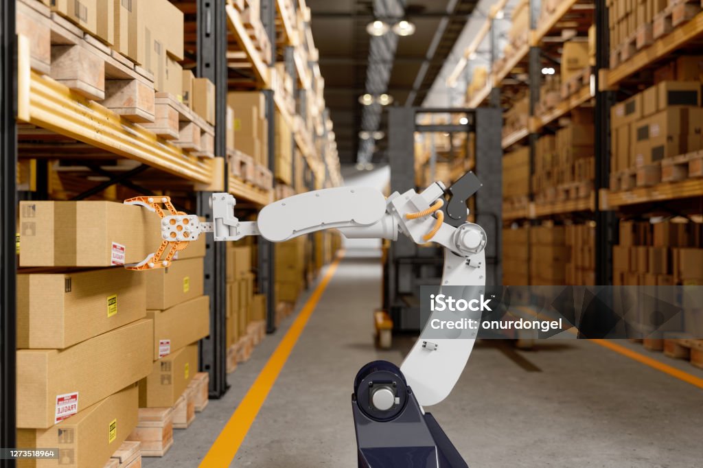 Robotic Arm Taking A Cardboard Box In The Warehouse Robot Stock Photo