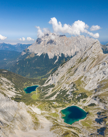 Aerial Panorama of the famous Lakes Drachensee and Seebensee with the highest german mountain Zugspitze in back. Two natural high mountain lakes at a height over 1,650 meters, south of Ehrwald in the Mieming Range. It is surrounded by the Vorderer Tajakopf in the east, the Vorderer Drachenkopf in the south and the Ehrwalder Sonnenspitze in the west. Converted from RAW.
