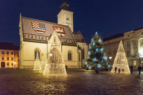 Illuminated Christmas trees in front of Saint Marks Church at St. Marks Square in the upper town of Zagreb during Advent time, Croatia