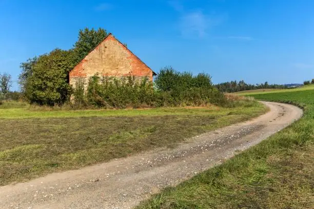 Old brick barn in the Czech countryside. Agricultural landscape. Hot summer day on the farm.