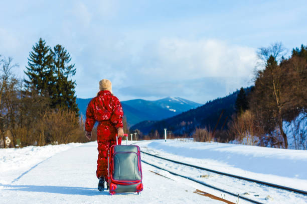 istock young woman in winter clothes waiting for her train 1273522012