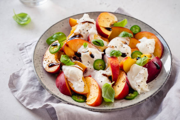 istock Fresh salad with Peaches and Buratta cheese 1273526411