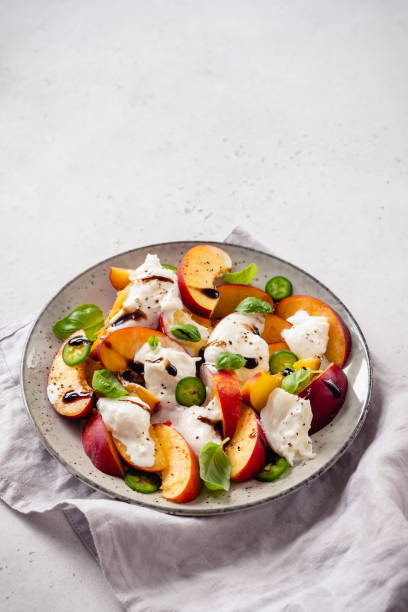 istock Fresh salad with Peaches and Buratta cheese 1273526429