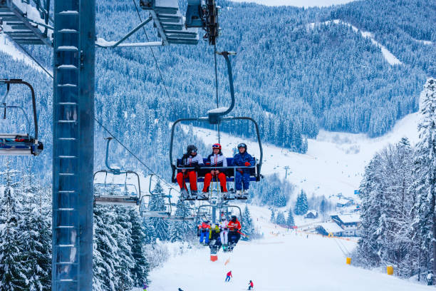 istock Skiing, ski lift - skiers on ski vacation 1273526675