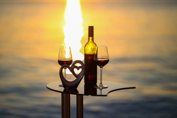 istock Composition of glasses and wine bottles at sunset 1273527446