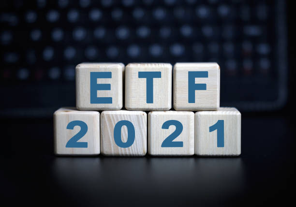 istock 2021 concept - ETF text in wooden cubes on a black keyboard 1273529652