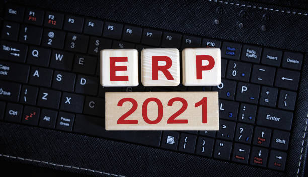 istock ERP 2021 concept. Wooden cubes on a black keyboard 1273529653