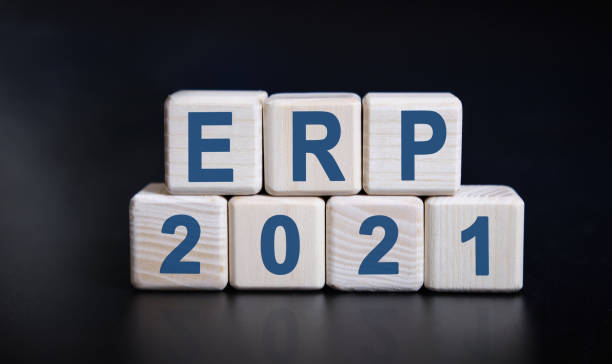 istock ERP 2021 text on wooden cubes on a black background with reflection. 1273529657