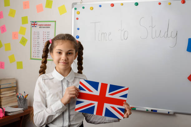 istock English learner of secondary school holds Union Jack flag standing in classroom of conventional school 1273529892