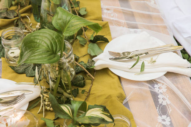 istock The table is served with white plate and vases with plants. 1273530502