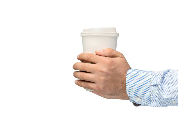 istock Man holding out a paper cup of coffee on white background 1273531191