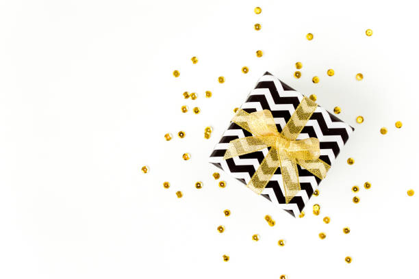 istock Gift or present box and stars confetti on a white background. Colorful celebration, birthday. Christmas or New Year pattern. Flat lay, top view 1273532160