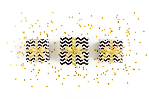 istock Gift or present boxes and stars confetti on a white background. Colorful celebration, birthday. Christmas or New Year pattern. Flat lay, top view 1273532188