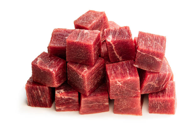 istock Cubes of raw beef meat isolated on white 1273537590