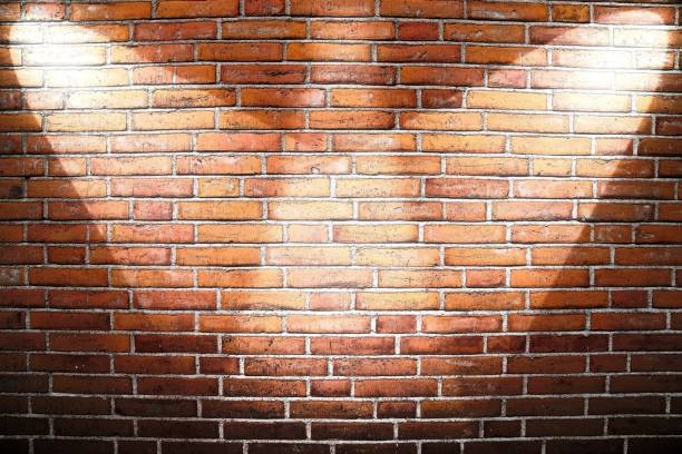 istock Aged and weathered brick wall textures with very bright spotlight illumination 1273538334