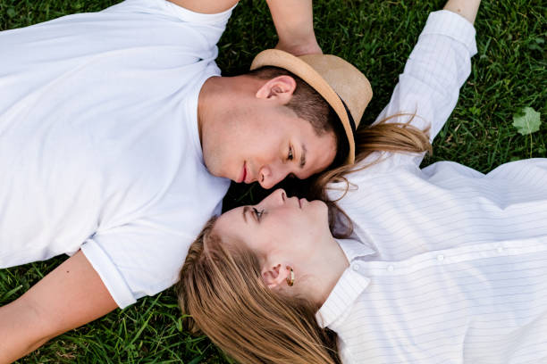 istock couple lying on the grass 1273542250