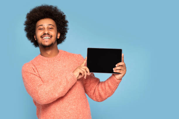 istock Happy African Man Holding Tablet 1273543296