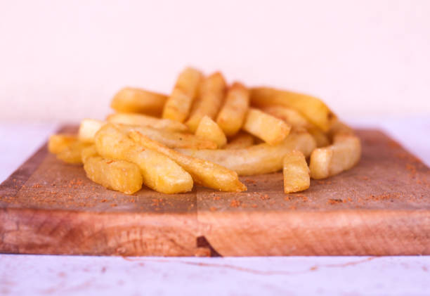istock french fries on wooden board. 1273543352