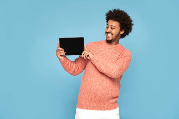 istock Happy African Man Holding Tablet 1273543988