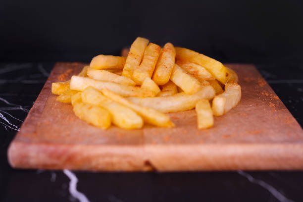 istock french fries on wooden board. 1273544278