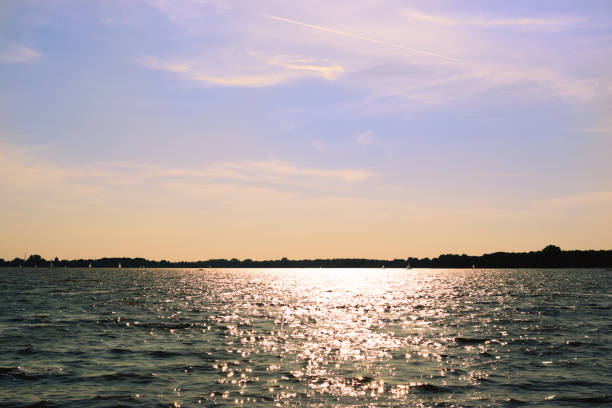 istock Calm lake in the sunshine with a cloudy sky 1273544302