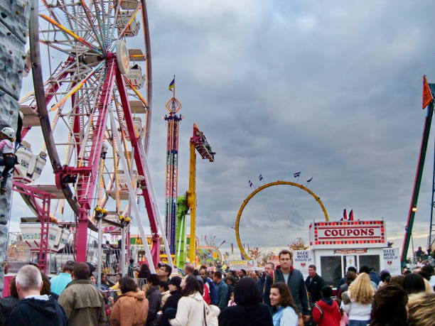 People enjoy the rides at the Midway at the Markham Fair in Ontario, Canada.. Markham, Ontario, Canada, October 4, 2008: People enjoy the rides at the Midway at the Markham Fair. This agricultural fair is one of Canada’s oldest dating back to 1844. midway fair stock pictures, royalty-free photos & images