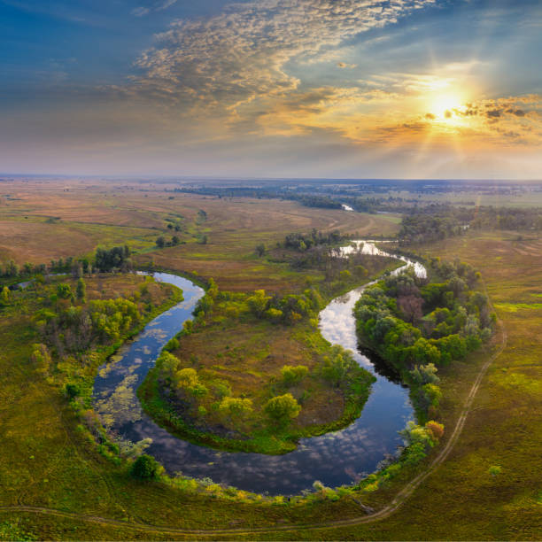 istock Mystical morning river, the sun's rays shine through the fog. 1273545948