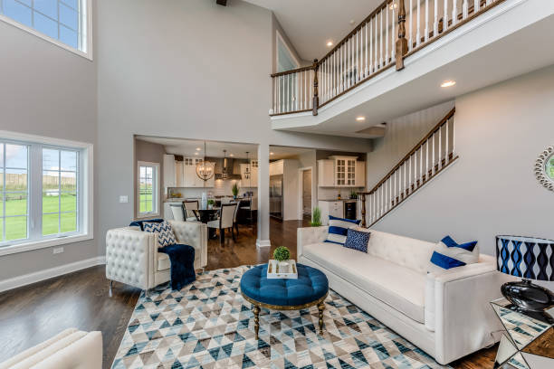 a six seater lounge or reception room in a luxury new home with two comfortable sofas, photographed during the evening with all of the lights on.