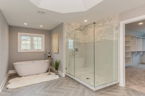 Master bathroom with freestanding tub and large all glass shower Patterned flooring with beautiful tray ceiling bathroom stock pictures, royalty-free photos & images