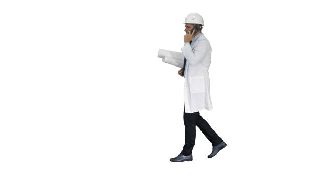 istock Successful architect is talking on the mobile phone and walking on white background 1273549891