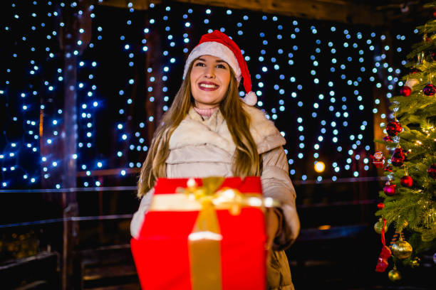 istock Woman holding Christmas present 1273554462
