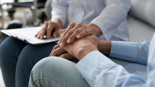 istock Supportive female nurse comfort lonely old lady patient 1273555369
