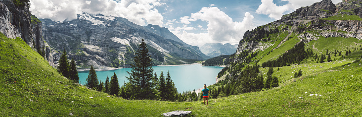 Panorama of Oeschinensee and mountains surrounding the lake in the summer.