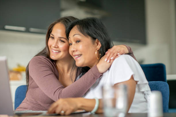 istock Mother and daughter video chatting together from home 1273555904