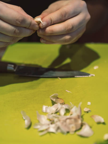 istock The young woman is peeling garlic 1273557584