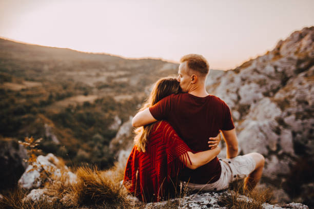istock Beautiful young couple relaxing after hiking 1273560447