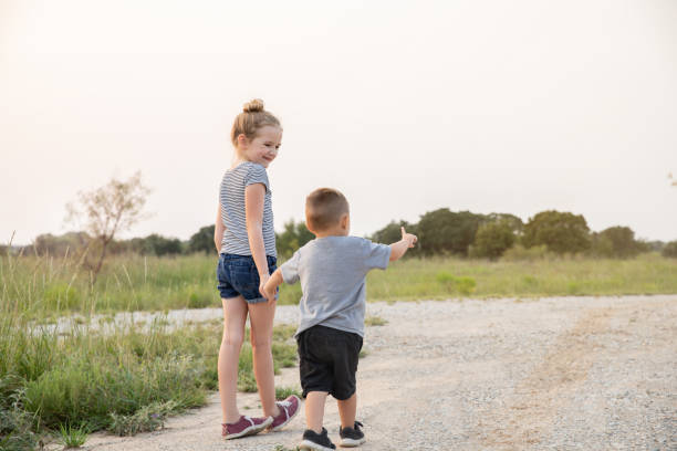 istock Young siblings go for walk outdoors together 1273561038