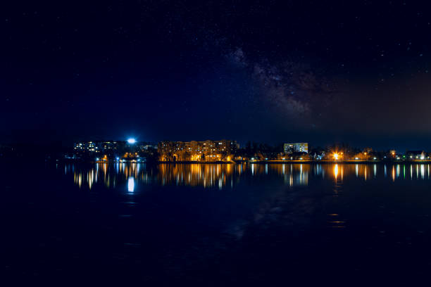 istock Dark sky with stars over the city 1273561930