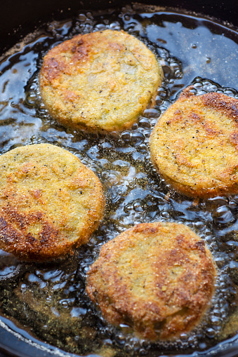 Fried Green Tomatoes Cooking in a Cast Iron Skillet