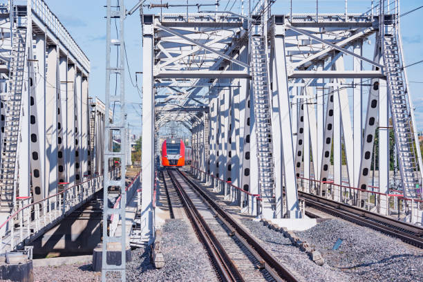 istock Highspeed train moves through the bridge approaching to the station platform. 1273565179
