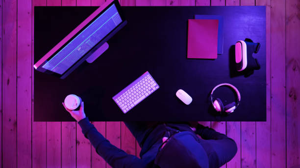 istock Male hooded gamer watching a game on computer 1273575228