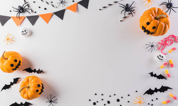 istock Halloween decorations made from pumpkin, paper bats and black spider on pastel orange background. Flat lay, top view with copy space for text. 1273575341