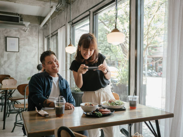 istock Asian young couples eating food at a cafe. 1273576851