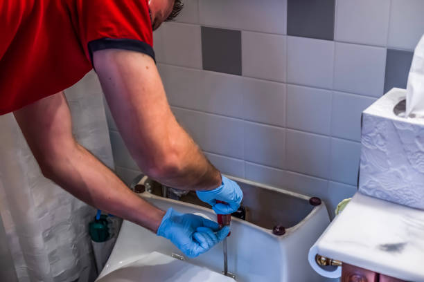 istock Plumber fixing toilet in bathroom 1273581073