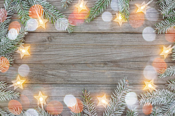 istock wooden background decorated with christmas tree branches and glowing star garlands 1273583508