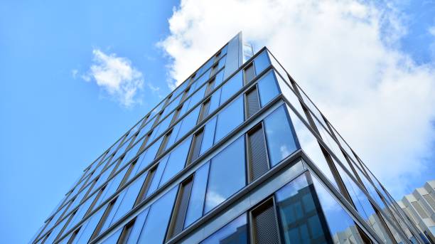 istock Office building, blue glass wall reflection detail. 1273587103