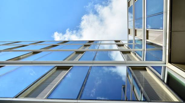 istock Office building, blue glass wall reflection detail. 1273588022