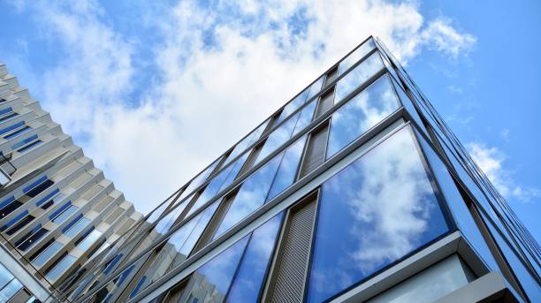 istock Office building, blue glass wall reflection detail. 1273588042