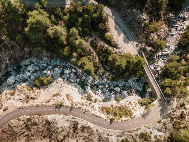 istock Road and bridge over mountain stream in Corsica 1273588284
