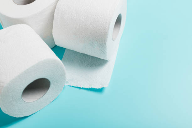 istock Three roll of white toilet paper on a blue background. 1273589835